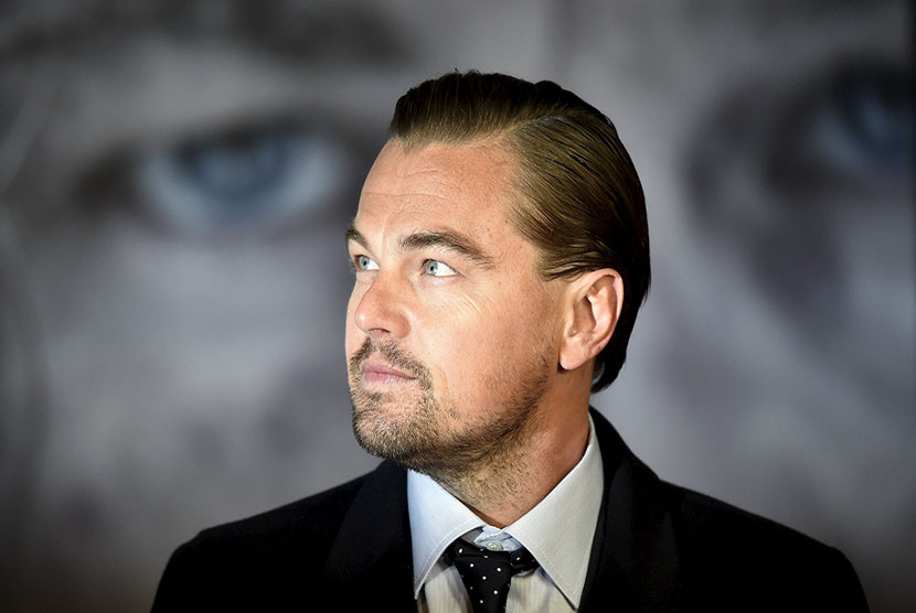 Actor DiCaprio poses as he arrives for the British premiere of "The Revenant", in London, Britain